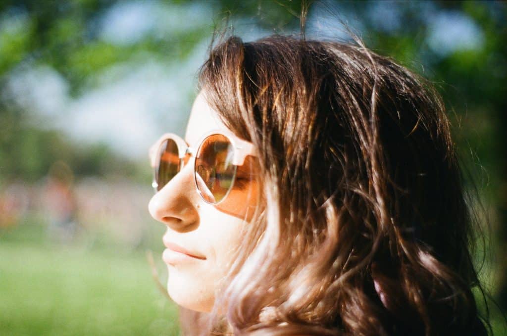 Woman enjoying being outside in nature in the sun