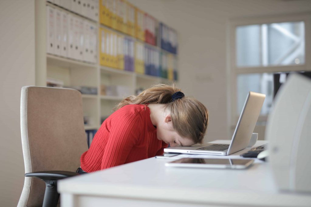 Exhausted woman sleeping in work